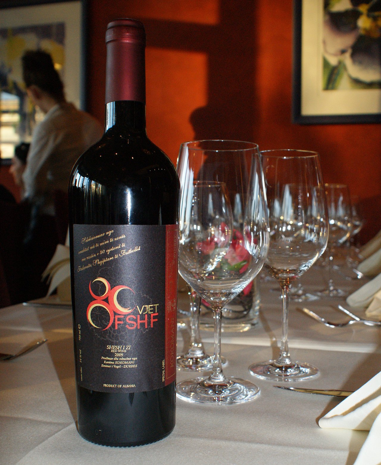 Bottle of red wine, dark glass, upright against a plain background